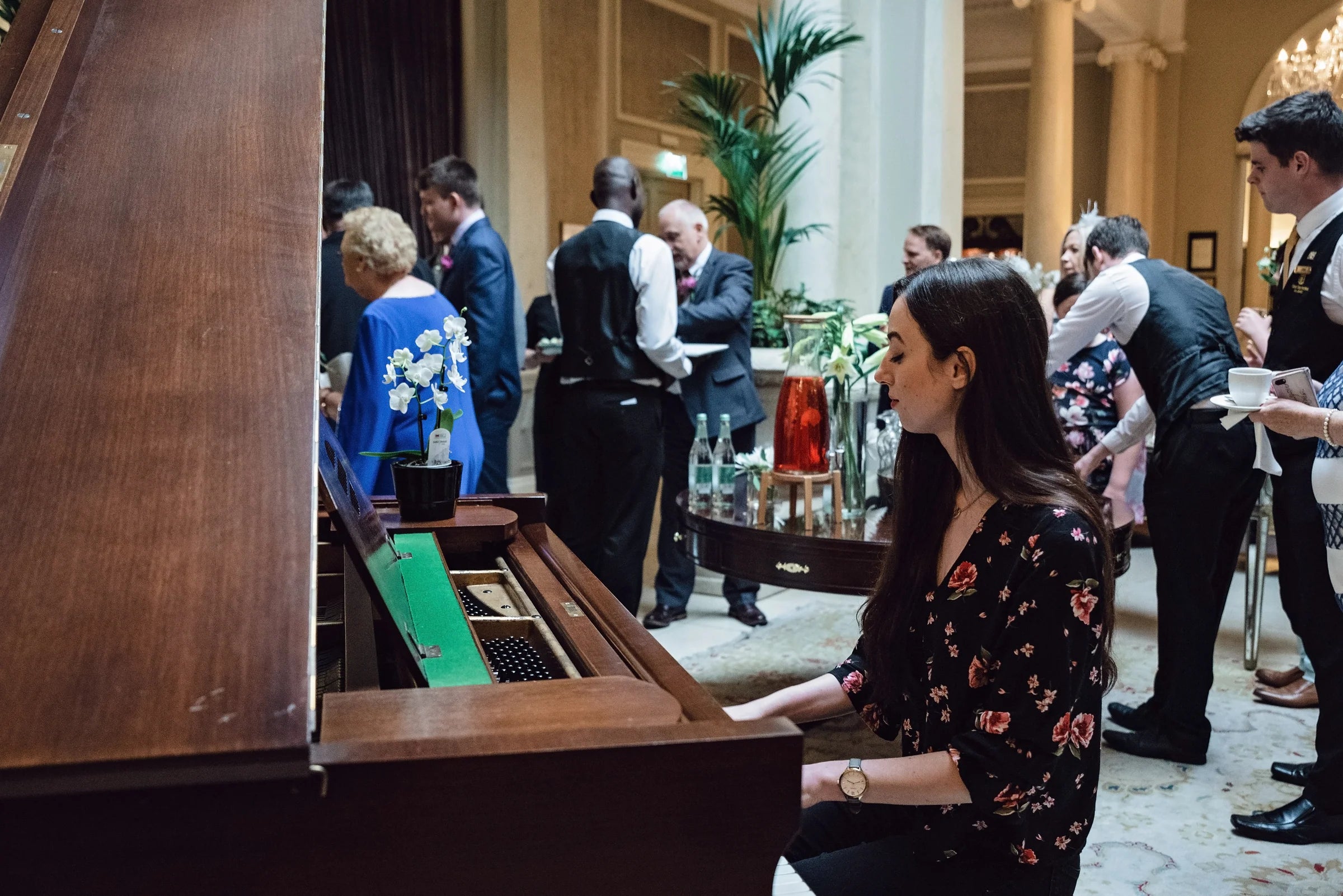 Claire Heffernan performing on a grand piano at a wedding reception.