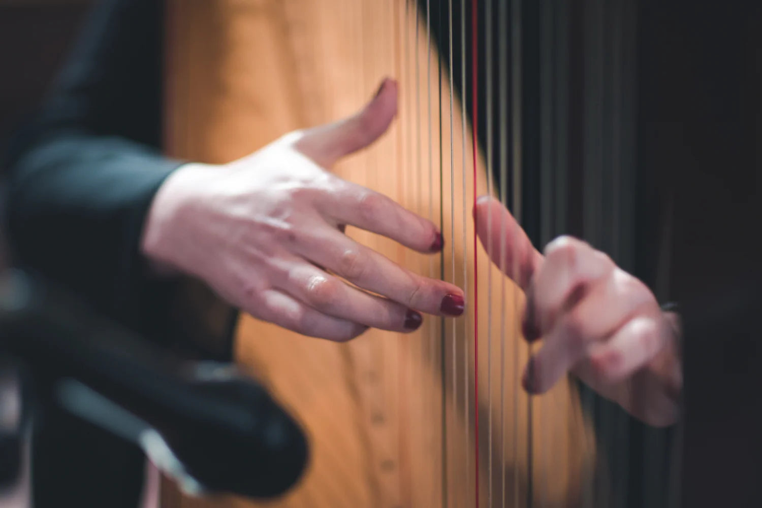Close-up of Claire Heffernan’s hands playing the harp.