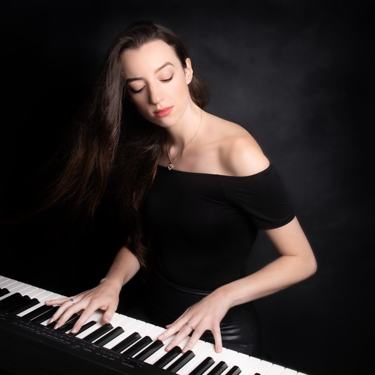 Close-up of Claire Heffernan playing the keyboard.