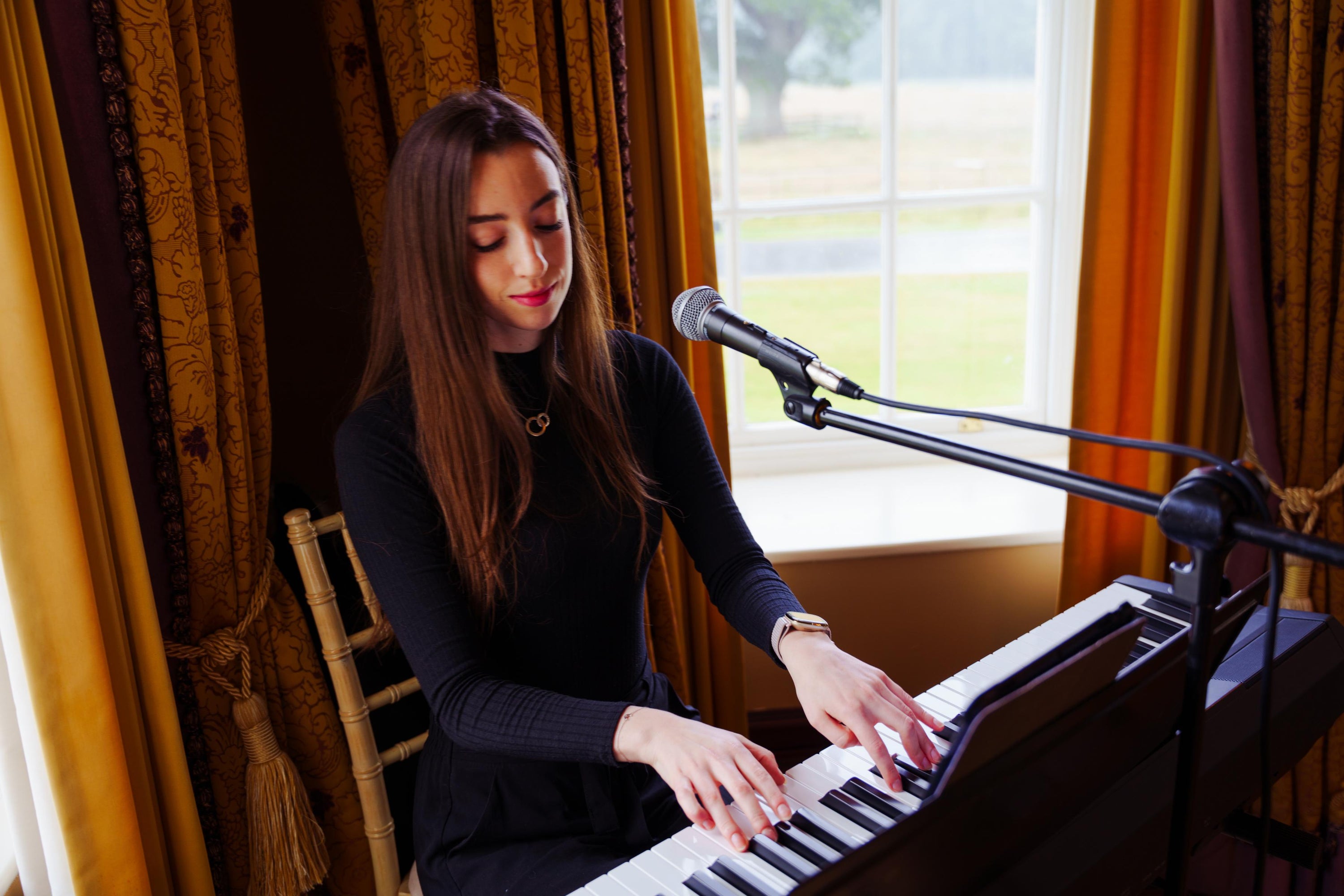 Claire Heffernan performing on keyboard at a wedding reception.