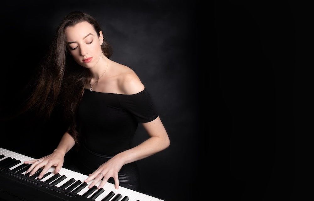 Close-up of Claire Heffernan playing the piano during a live wedding performance.