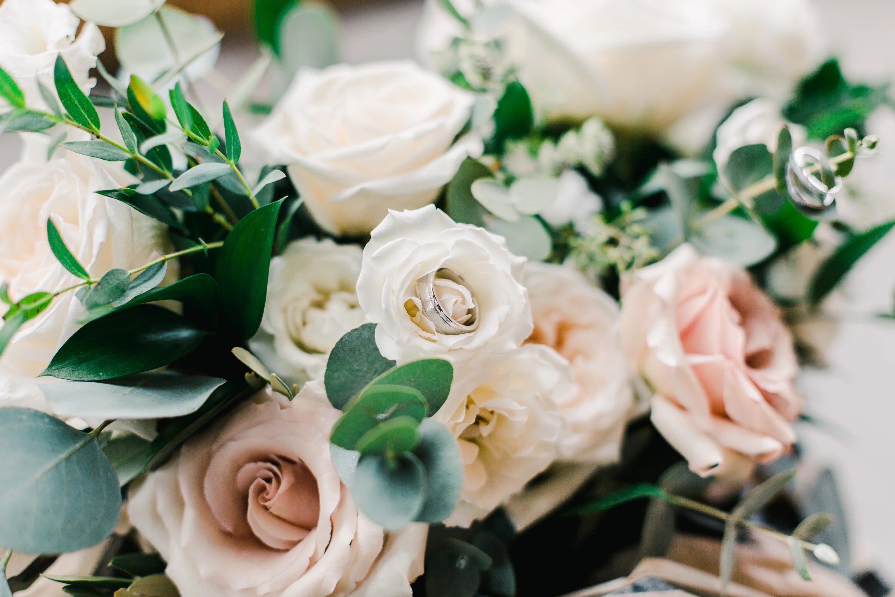A close-up of an elegant wedding bouquet with soft floral details.