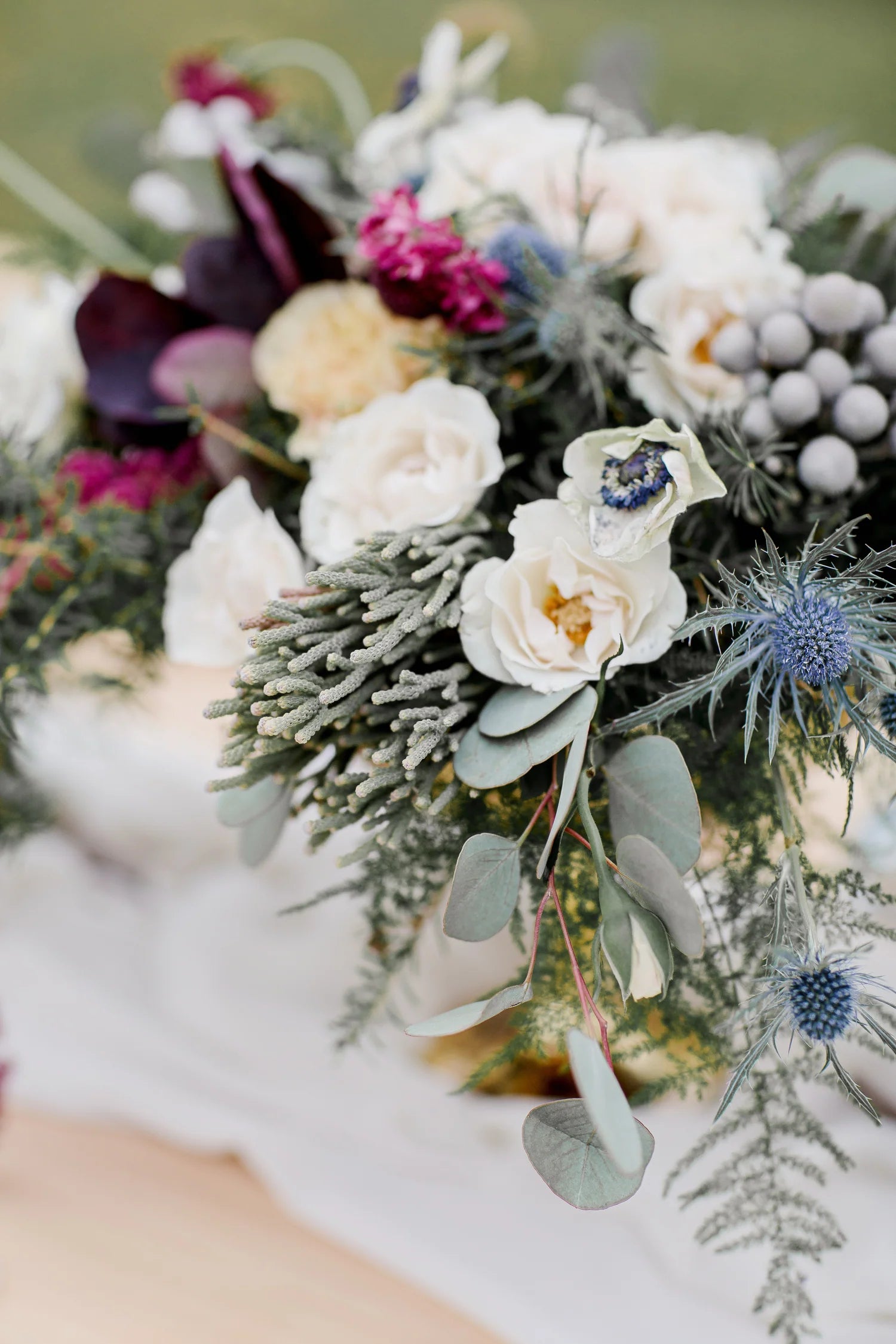 A close-up of a seasonal wedding bouquet featuring soft, natural blooms.